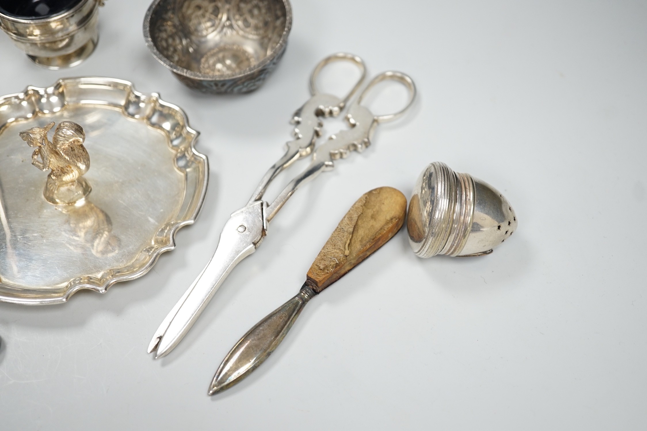 A 1920's silver mounted manicure stand with mirror and three associated implements, a small silver two handled salt, modern silver bowl, continental repousse white metal bowl, boxed modern silver letter opener and four p